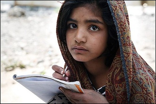 A girl studying in Pakistan's flooded area.